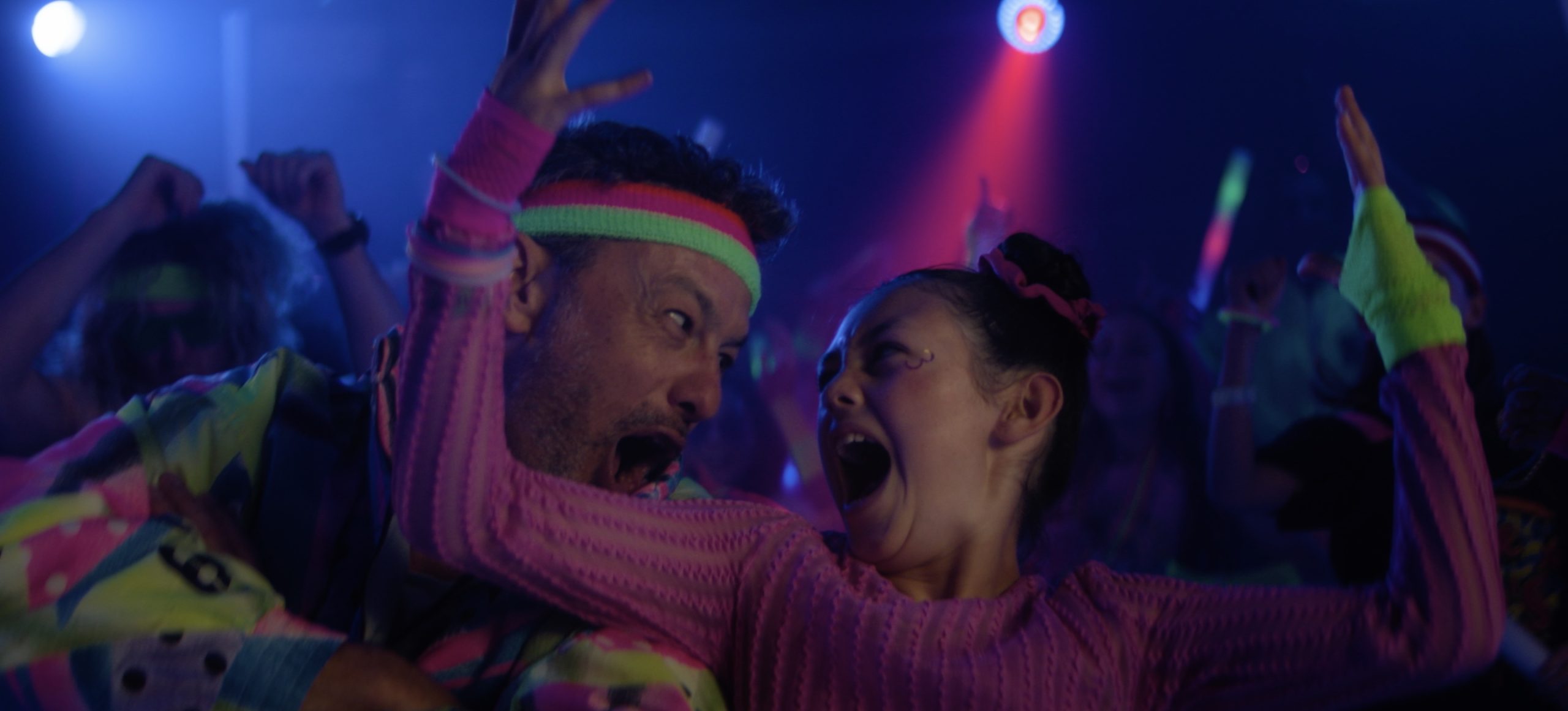 Father and Daughter dancing together in neon clothes